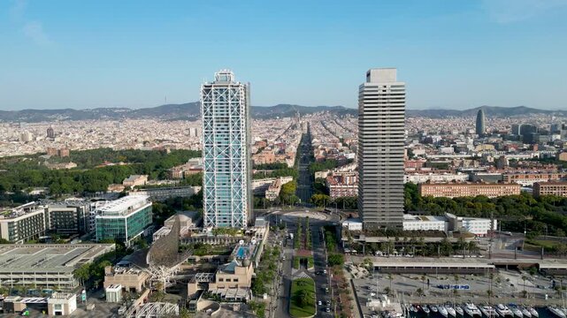 Aerial view of the iconic Hotel Arts and Torre Mapfre rising above the city, contrasting with the blue Mediterranean sea, Barcelona, Catalonia, Spain.