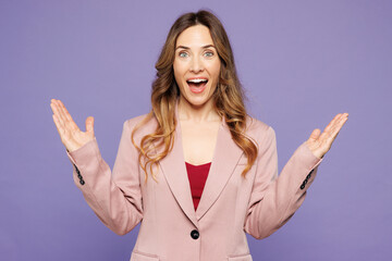 Young shocked surprised amazed fun impressed woman she wearing beige jacket formal clothes look camera spread hands isolated on plain pastel light purple background studio portrait. Lifestyle concept.