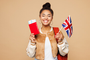 Young traveler tourist girl student wear casual clothes backpack bag hold passport ticket British...