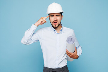 Young pensive minded sad mad architect engineer designer employee man wear white clothes shirt...