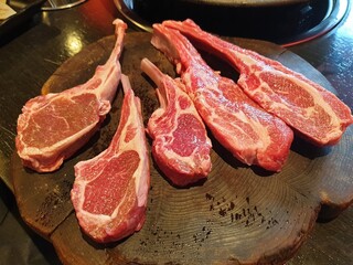 Raw Lamb Chops on Wooden Board Ready for Cooking