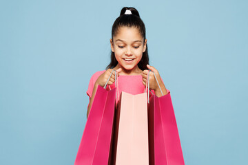 Little smiling surprised satisfied kid girl 9-10 years old wear pink clothes hold in hand open...