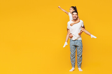 Full body young parent man with child girl wear blue pyjamas clothes. Daddy little kid giving...