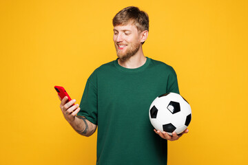 Young happy man fan wear basic green t-shirt cheer up support football sport team hold in hand...