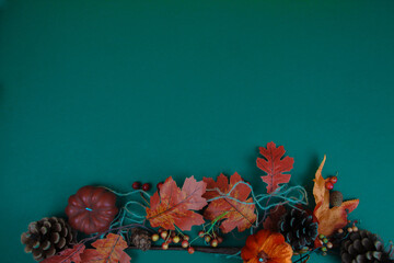 Dark green background decorated with autumn attributes.Space for text.