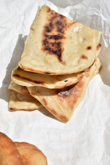 Golden Brown Flatbread on White baking Paper top view