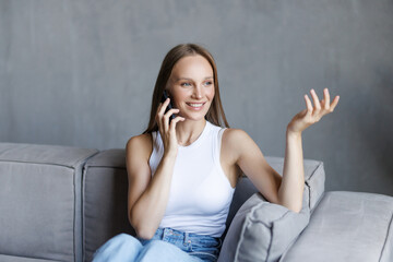 Feminine gossip on the phone while relaxing on couch