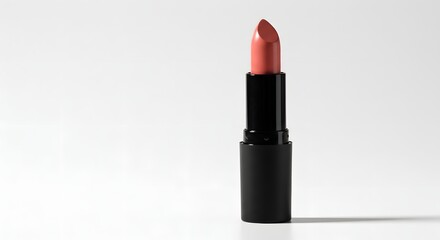 Lipstick a coralcolored cosmetic in a black tube casting a shadow on a white backdrop
