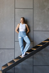 Young woman standing on a home stairs