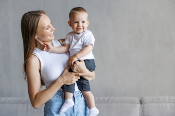 Loving mother hugs her little son at home