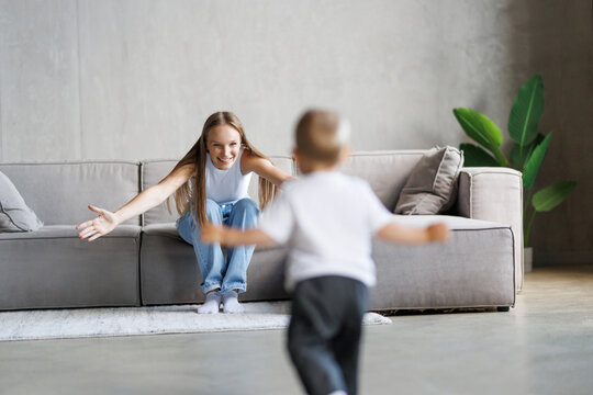 Baby toddler son have a fun running in living room with his mother - Powered by Adobe