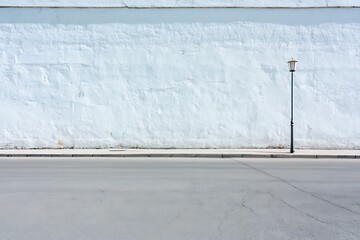 urban pathway with extensive white concrete wall surface featuring space for mockup content
