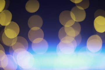 Fototapeta premium Abstract bokeh background. Golden bokeh circles on dark blue background. Layer overlay.