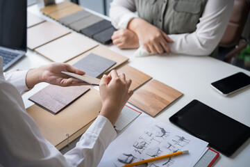 Interior designer presenting eco friendly wooden material samples for sustainable home decor