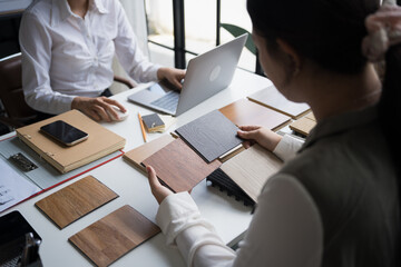 Fototapeta premium Interior designer presenting eco friendly wooden material samples for sustainable home decor