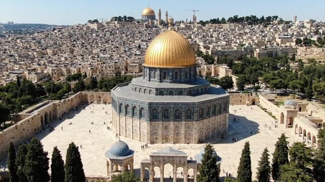 Panoramic drone shot of the sacred Dome of the Rock with its iconic golden dome and ornate blue tiles surrounded by the historic architecture of Jerusalems Old 