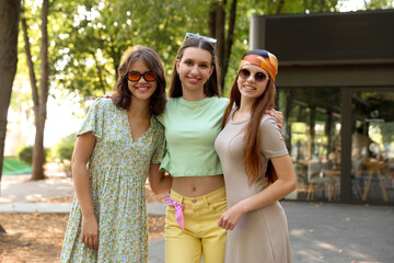Portrait of happy friends with sunglasses outdoors