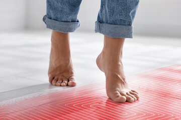 Woman walking barefoot on warm floor, closeup. Underfloor heating system, double exposure