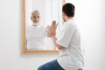 Man seeing himself as elder in mirror. Conceptual collage about past and future, flow of time, age