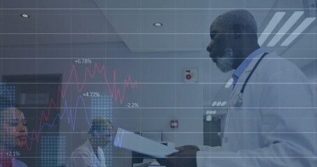 Mature male physician reviewing charts in hospital room, colleagues watching, digital overlay