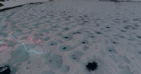 Displaying snow-covered ice sheet revealing melt holes on frozen expanse, with red blue line graphs