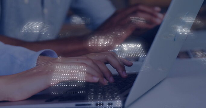 Typing professional hands entering data on laptops in modern office, with glowing digital overlay