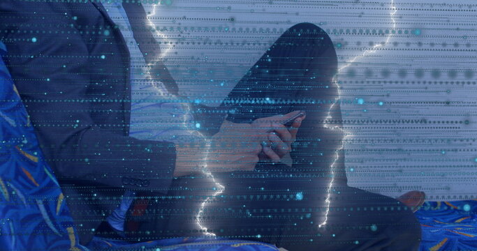 Fototapeta Scrolling businessman wearing suit on blue bus seat, with smartphone under digital code overlay