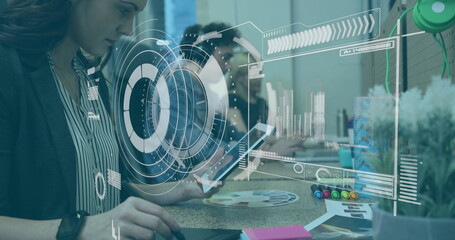 Operating mature woman moving mouse at office with tablet stylus and holographic charts, copy space