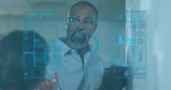 Presenting data, tech professional holding tablet in conference room, with holographic charts