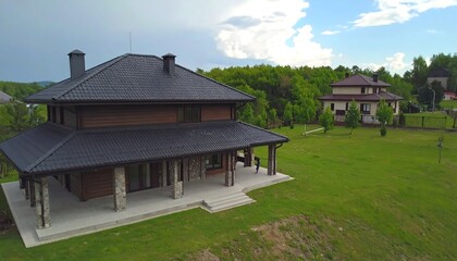 Aerial view of two modern houses in a grassy landscape