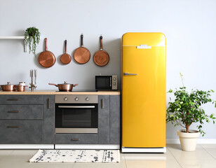 Charming Kitchen Scene A butter-yellow fridge enhances the ambiance with copper pans and a contemporary design.