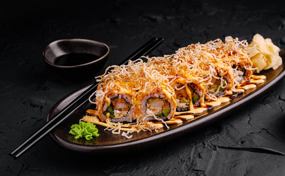 Delicious sushi rolls served on a stylish platter with fresh garnish