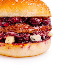 Juicy burger with berry sauce and cheese on sesame seed bun
