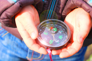 Classic shiny compass in child's hands