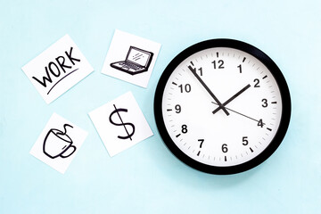 Wall clock and many paper cards with hand drawing of different life activities, top view. Time...