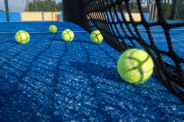 Sports background with a single padel ball in sharp focus.