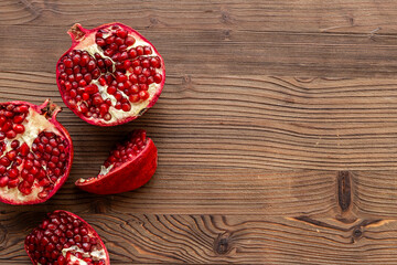 Top view of fresh ripe pomegranate with half and pieces ready for eating