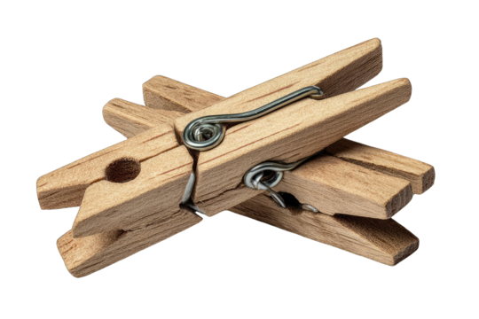 Close-up of two crossed wooden clothespins