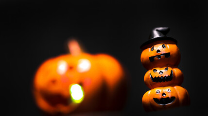 Halloween tower orange pumpkin with candle on black background