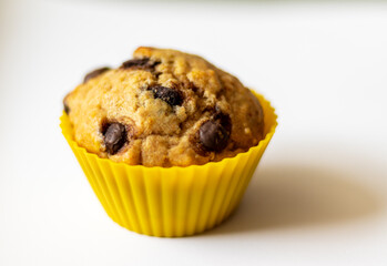 Image of a chocolate chip banana cupcake with white background