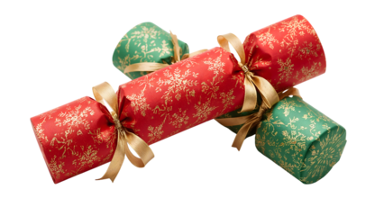 Festive christmas crackers with gold ribbons, red and green decorative wrapping, traditional holiday celebration favors isolated on white