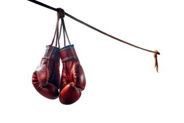 A pair of vintage red leather boxing gloves hanging from a rope, isolated on transparent background, evoking a sense of nostalgia and the history of the sport