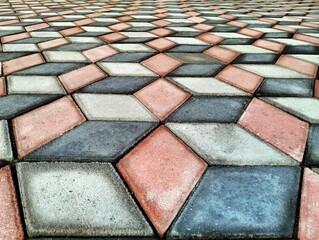 A paving block pattern creates an optical illusion. With a combination of dark gray, light gray,...
