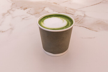 Vibrant iced matcha latte: Intense emerald green matcha tea blended with creamy milk and ice,...