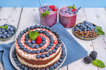 Valentine's Day Cake: Red Velvet hearts with pale pink frosting and blueberries in the shape of a...