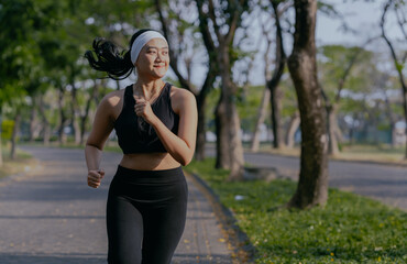 Beautiful asian fitness female sportswoman runner doing morning jogging exercise training outdoor.