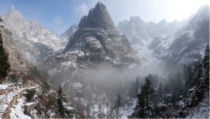 Snowy mountain peaks, mist-shrouded valley