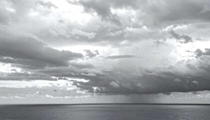 Overcast grayscale sky with layers of gray clouds above the ocean before a rainstorm atmospheric weather