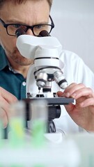Man scientist using microscope in laboratory. Microbiology science concept