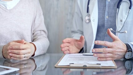 Doctor and patient conversation with clipboard in clinic office. Medicine and Health care